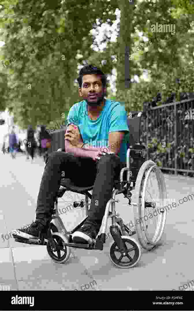 Rajendra, A Young Man In A Wheelchair, Smiling And Holding A Book Narratives Of Courage: Lives Of Spinal Cord Injured Survivors In India