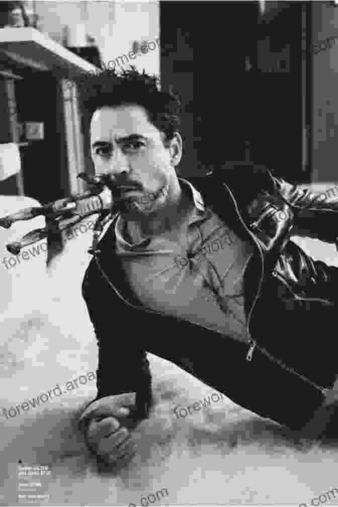 Robert Downey Jr. In A Pensive Pose, Looking Thoughtful And Enigmatic. Inside The Mind Of An Iron Icon: On Strength Training And Bodybuilding